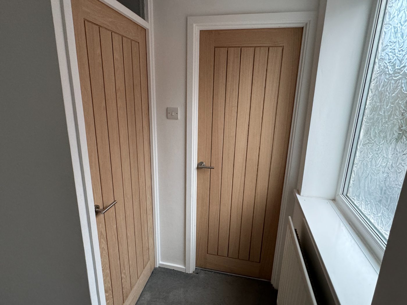 Cottage-style oak doors with brushed steel handles