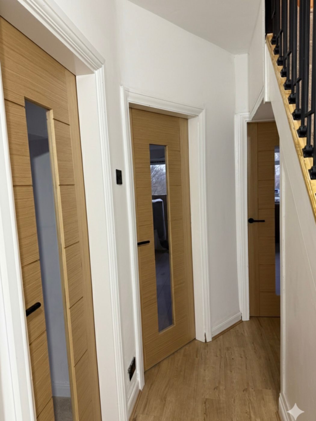 Glazed oak doors fitted through a finished hallway